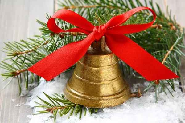 Golden bell with red satin ribbon bow — Stock Photo, Image