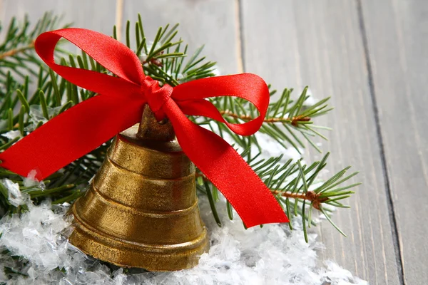 Golden bell with red satin ribbon bow — Stock Photo, Image