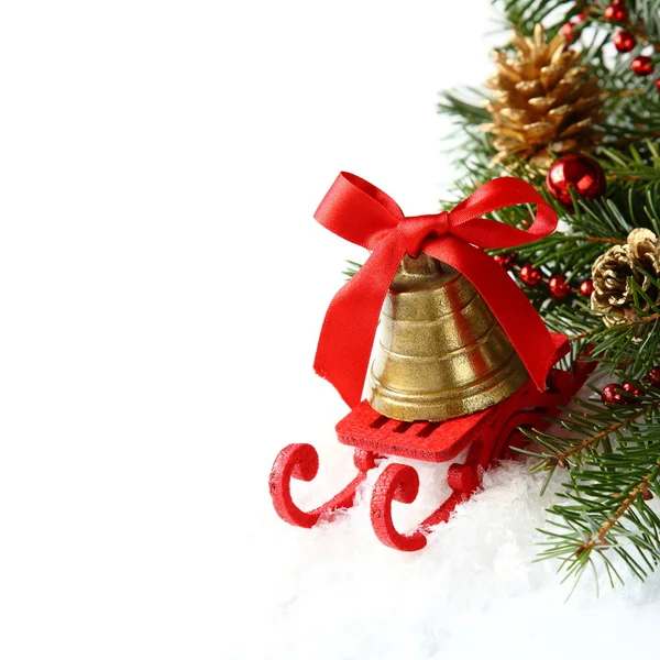 Christmas composition with sleigh and golden bell over white — Stock Photo, Image