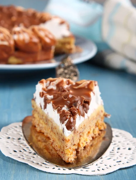 Slice of almond cake with chocolate and cream — Stock Photo, Image