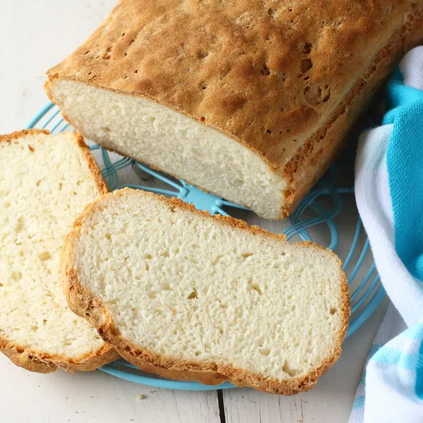 Homemade gluten free bread on blue metal grid — Stock Photo, Image