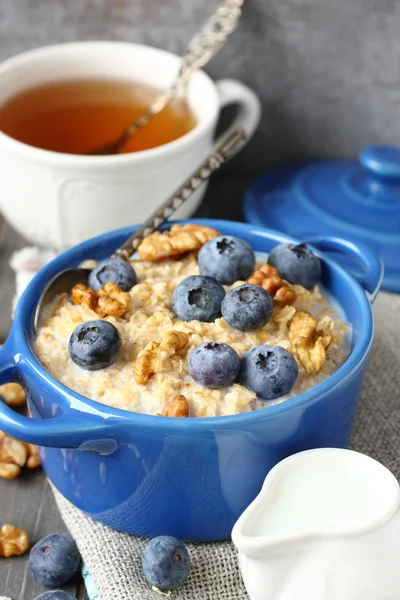 Oatmeal with fresh blueberries over a rustic wooden background — Stock Photo, Image