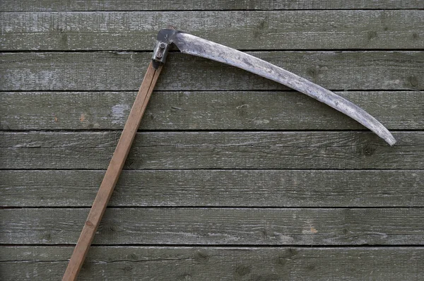 Scythe on wooden background — Stock Photo, Image