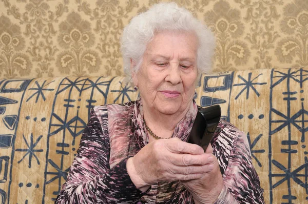 Senior woman dials the phone — Stock Photo, Image