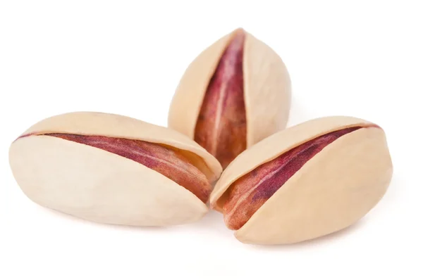 Three pistachios on white — Stock Photo, Image
