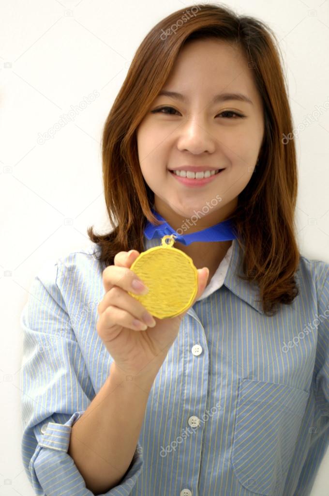 Young Businesswoman holds up her gold medal