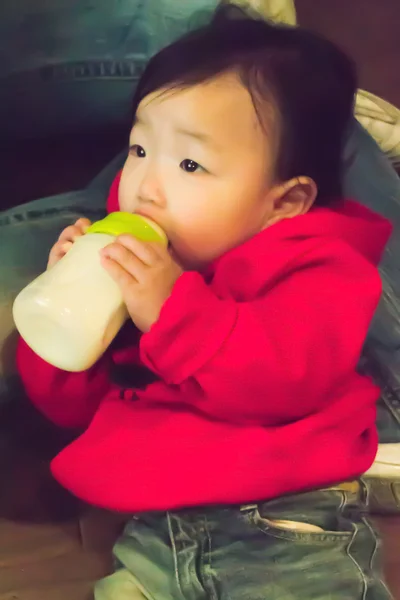 Baby girl drinking her bottle — Stock Photo, Image