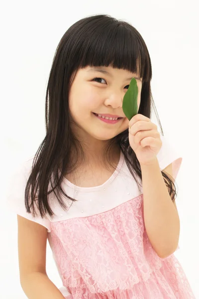 Beautiful asian girl with a leaf — Stock Photo, Image