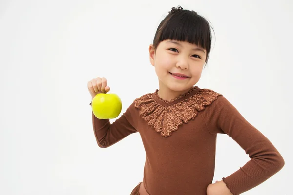 Cute asian kid with an apple — Stock Photo, Image
