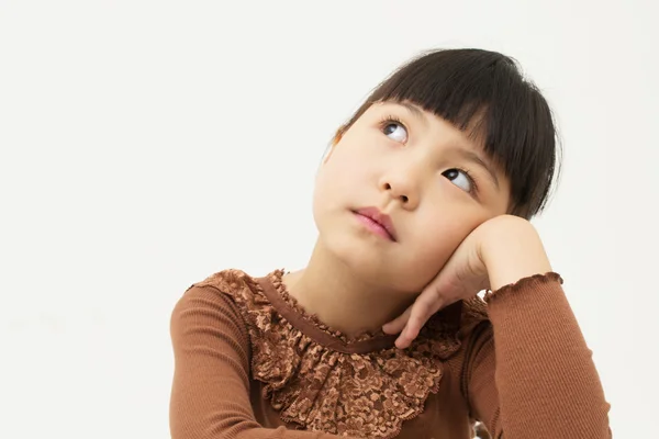 Beautiful little young girl rest her chin on her hand — Stock Photo, Image