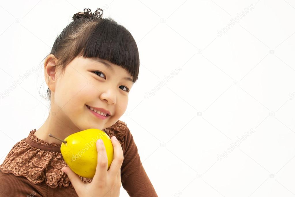 Cute asian kid with a quince