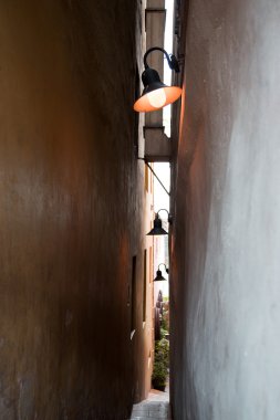 narrow street in Prague with pedestrian traffic lights clipart