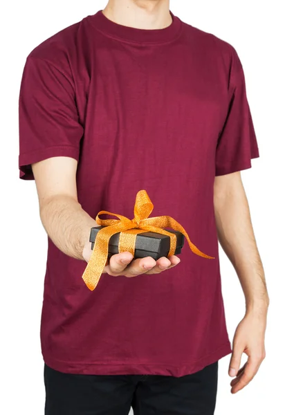 Man in T-shirt holding gift box — Stock Photo, Image