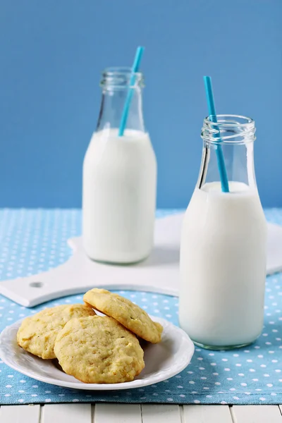 Lemon cornmeal cookies with a bottle of milk — Stock Photo, Image