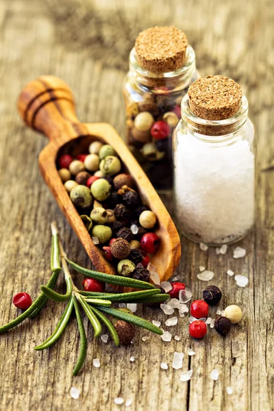 Salt and pepper on wooden table — Stock Photo, Image