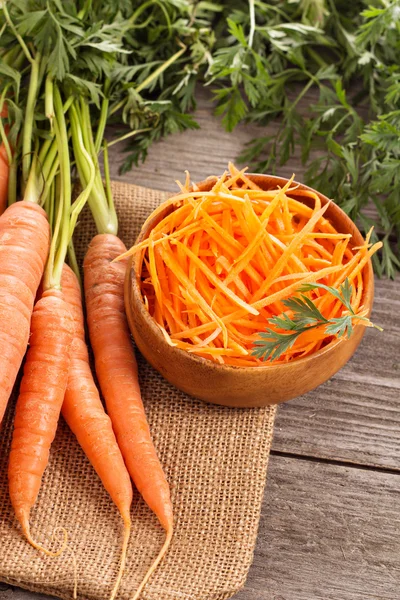 Fresh carrot, whole and grated — Stock Photo, Image