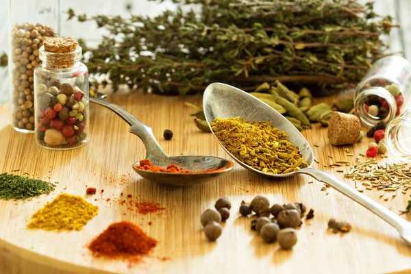 Variety of spices and herb on a wooden board — Stock Photo, Image