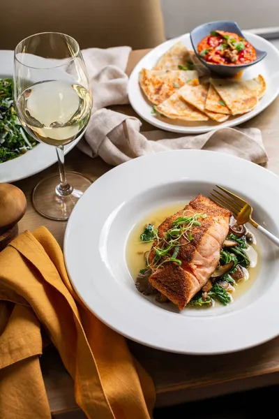 Roasted salmon served on top of greens — Stock Photo, Image