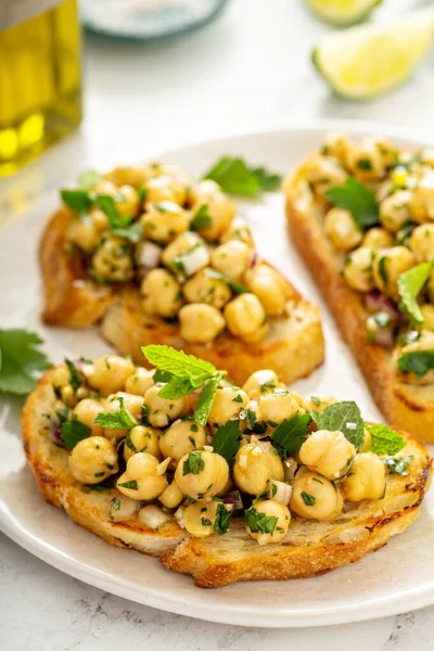 Healthy bruschetta with chickpea salad and herbs — Stock Photo, Image