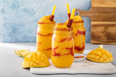 Mangonada mexican mango smoothie with chamoy sauce and lime seasoning clipart