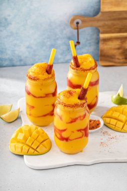 Mangonada mexican mango smoothie with chamoy sauce and lime seasoning clipart