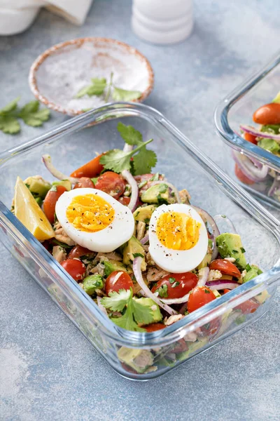 Meal prep containers with avocado tuna salad and boiled egg