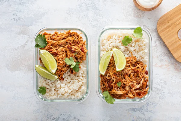 Meal prep containers with pulled chicken with salsa and rice