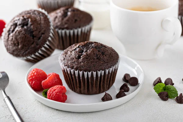 Chocolate muffins served with coffee with raspberries — Stock Photo, Image