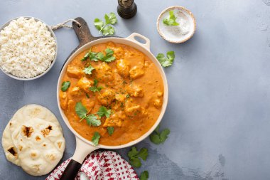 Chicken tikka masala, cooked marinated chicken in spiced curry sauce clipart