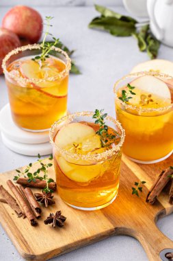 Hard apple cider cocktail with cinnamon and thyme, fall drink concept