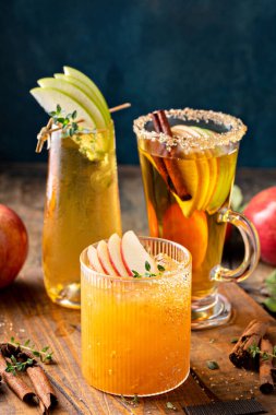 Variety of fall cocktails or mocktails made with apple cider, Thanksgiving drinks ideas