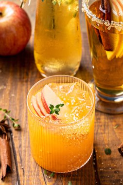 Apple cider margarita with apple slices, cinnamon and fresh thyme, fall cocktail or mocktail idea