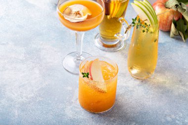 Variety of fall cocktails or mocktails made with apple cider in a light and bright setting, fall brunch drinks ideas