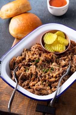 Pulled pork on a serving platter, ready to eat and make sandwiches