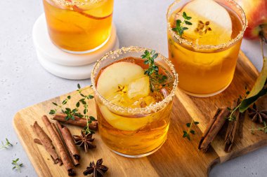 Hard apple cider cocktail with cinnamon and thyme, fall drink concept
