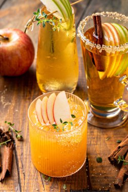Variety of fall cocktails or mocktails made with apple cider, Thanksgiving drinks ideas