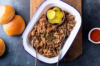 Pulled pork on a serving platter, ready to eat and make sandwiches