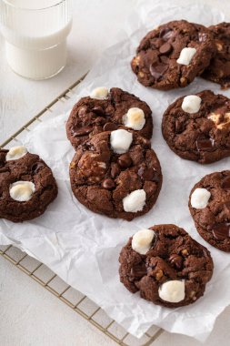 Chocolate chip and marshmallow dark chocolate cookies served with milk