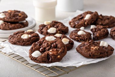 Chocolate chip and marshmallow dark chocolate cookies served with milk