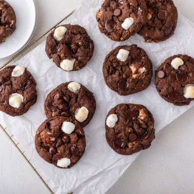 Chocolate chip and marshmallow dark chocolate cookies served with milk