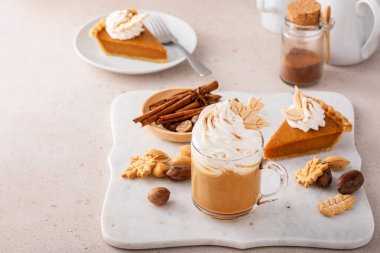 Pumpkin spice latte topped with whipped cream and dusted with cinnamon