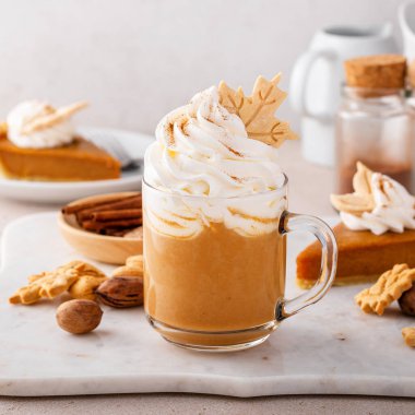 Pumpkin spice latte topped with whipped cream and dusted with cinnamon