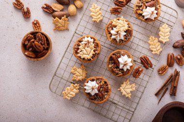 Mini pecan pies baked in a muffin tin, traditional fall or Thanksgiving dessert