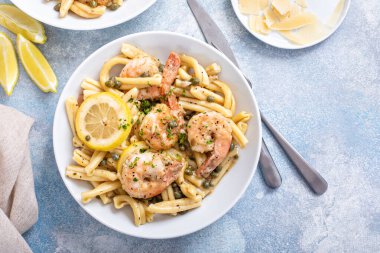 Shrimp piccata pasta with lemon, capers and parmesan in a pasta bowl