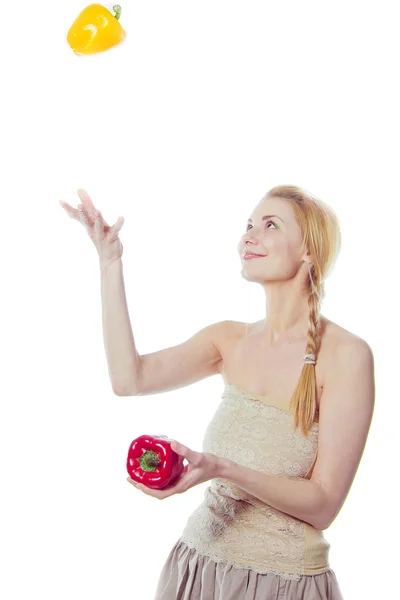 Woman with yellow and red peppers — Stock Photo, Image