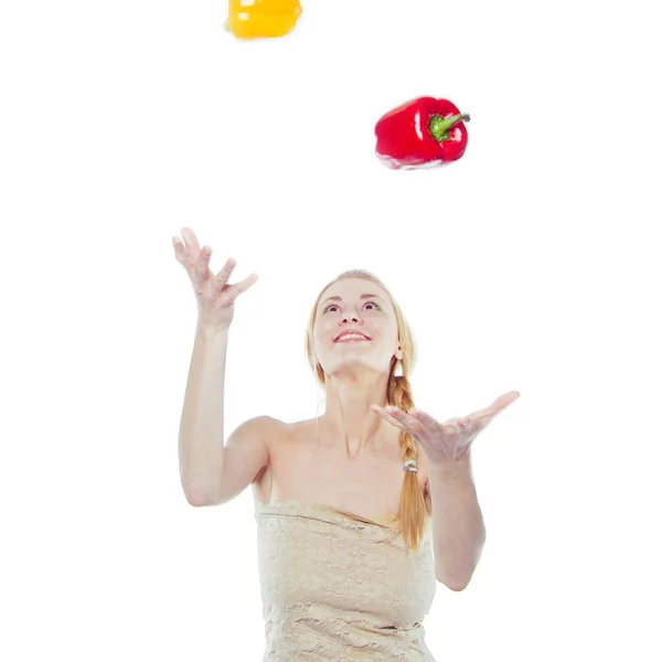 Woman with yellow and red peppers — Stock Photo, Image