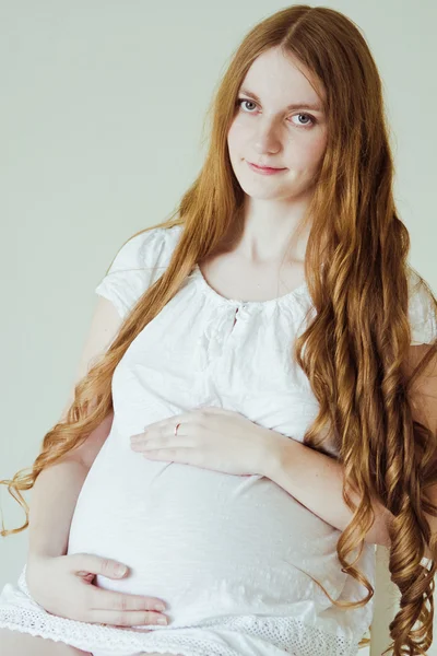 Těhotná žena sedí na židli — Stock fotografie