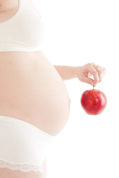Mujer embarazada con manzana roja — Foto de Stock