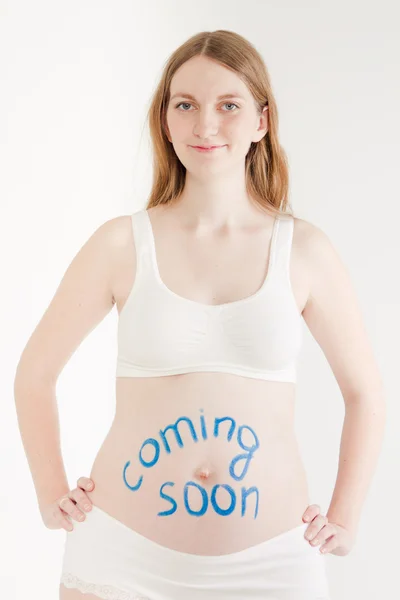 Pregnant woman with caption on stomach — Stock Photo, Image