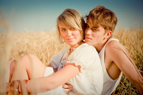 Bilden av ung man och kvinna på vete fält — Stockfoto